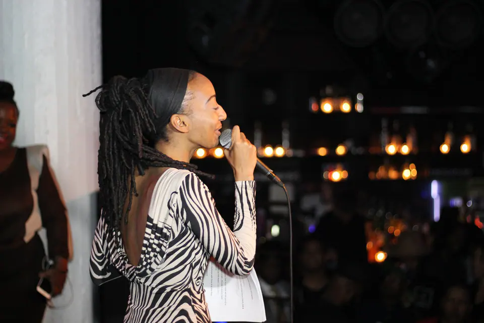 Donna Marie speaking into a microphone on stage